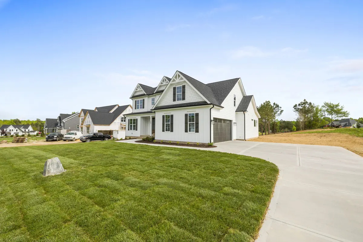 A poured concrete driveway curving from the street to a two-car garage